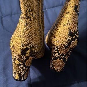 Snake print knee high boots